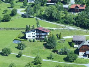 an aerial view of a house on a green field at Cozy Apartment in Afritz am See near Gerlitzen Ski Area in Afritz