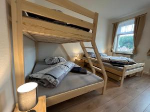 a bedroom with two bunk beds and a window at Alles Gute Wehlen in Stadt Wehlen