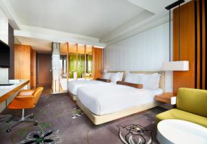 台北的住宿－台北W 酒店，卧室配有一张白色大床和一张书桌