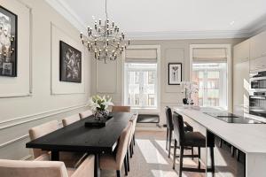 a dining room with a black table and chairs at Sofiesgate Lux Apartment in Oslo