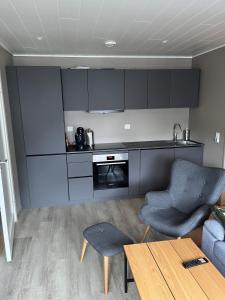 un soggiorno con cucina, tavolo e divano di New Apartment 2 bedroms a Stryn