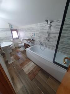 a bathroom with a tub and a sink at La Dolce Sosta - Tuscany in Chianciano Terme +19 photos