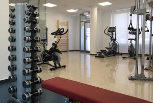 a gym with treadmills and elliptical machines at AGH Canet in Canet de Berenguer