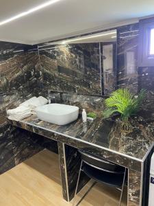 a bathroom with a sink on a marble counter at Κτήμα Mairy΄s House in Flogita +35 photos
