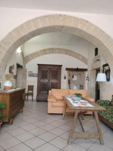 a living room with a couch and a table at La Casa Rossa in Riola Sardo