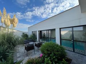 a house with a patio and a swimming pool at Vera HOTEL-VILLA in Prishtinë