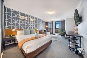 a bedroom with a large bed and a desk at KozyGuru | Sydney CBD | 1Bed Studio | Dis-ney Theme °o° in Sydney