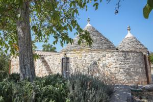 an old stone building with two towers at Trulli Dimore - Trulli della Lama in Castellana Grotte