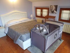 a bedroom with a large bed and a crib at La Dolce Sosta - Tuscany in Chianciano Terme