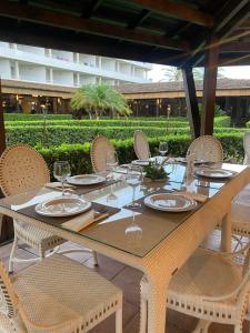 a table with chairs and plates and wine glasses at AGH Canet in Canet de Berenguer