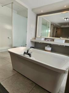 a large bathroom with a sink and a mirror at Central - Whale Watching Paradise -Self check in in Hermanus +17 photos