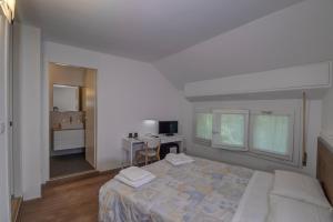 A bed or beds in a room at Il Colombé B&B