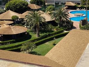 an aerial view of a resort with palm trees and a pool at AGH Canet in Canet de Berenguer