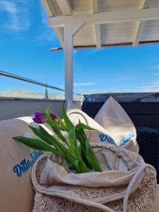 a bouquet of purple flowers in a towel at Apartments Silva in Trogir