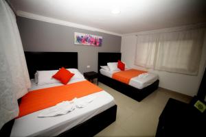 Giường trong phòng chung tại Hotel San Marcos Barranquilla