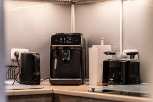 a kitchen with two coffee machines on a counter at Ferienwohnung Haus am See in Kaufungen