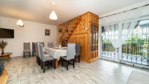 a dining room with a table and chairs at Kútvölgy Vendégház in Vác