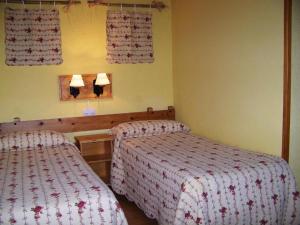 En eller flere senge i et værelse på Hotel Prats