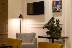 TV a/nebo společenská místnost v ubytování Mascagni Luxury Rooms & Suites