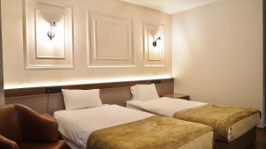 Postel nebo postele na pokoji v ubytování Aktas Hotel