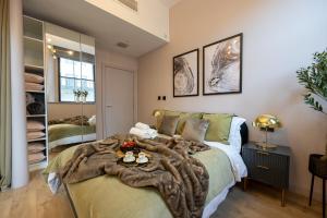 a bedroom with a bed with a blanket on it at Elegant & Luxurious - Central Chinatown Residence in Manchester