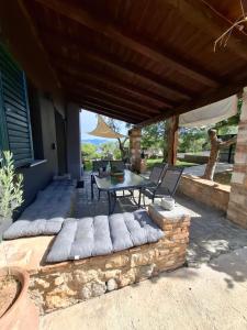 a patio of a house with a table and chairs at Dimitra's Villa in Evia, Greece in Loukísia