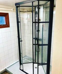a glass shower stall in a bathroom with at Ofvansjö Gård , Enkel stuga för övernattning på ett fd militärområde in Sandviken
