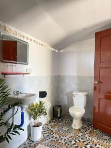 a bathroom with a toilet and a sink at Residencia Gemma in Siquijor