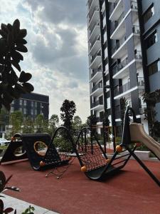 a group of playground equipment on a city street at Cozy n New Eco Style in Teluk Panglima Garang