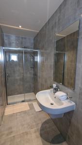 a bathroom with a sink and a shower at Hotel Blackpool in Blackpool