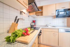a kitchen with a bunch of vegetables on a counter at Penthouse STRANDDÜNE mit Meerblick in Sassnitz