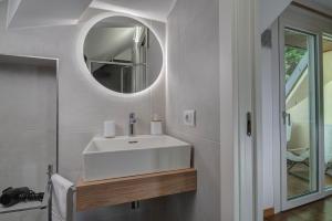 a bathroom with a white sink and a mirror at Il Colomb&eacute; B&B in Barzan&ograve;