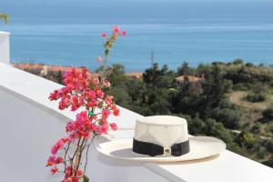 a hat and flowers sitting on a white ledge at Amazing Penthouse in Costa del Sol in Rincón de la Victoria