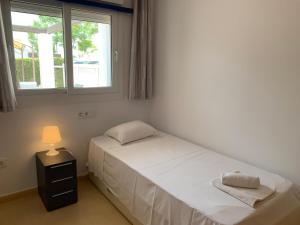 a small bedroom with a bed and a window at Condado de Alhama NARANJOS 2 SV69 in El Romero