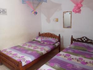 Ένα ή περισσότερα κρεβάτια σε δωμάτιο στο Kunam Beach Rest Inn