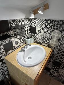 een badkamer met een witte wastafel en zwarte en witte tegels bij Escapade en Montagne, 3 pers in Saint-Étienne-de-Tinée +20 foto's