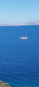a boat in the middle of a large body of water at Datca Villa Carla Hotel in Datca