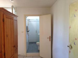 a bathroom with a toilet and a door to at Maison Hôtes Villa Sainte Barbe in Mirecourt