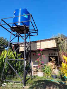 a blue barrel sitting in the yard of a house at Bogenvil villa in Tanjung