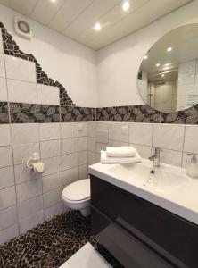 a bathroom with a toilet and a sink and a mirror at Pools, Sauna und Balkon mit Panoramablick in Sankt Englmar