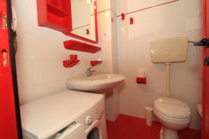 a small bathroom with a sink and a toilet at Eco del Mare Apartments in Lido di Pomposa