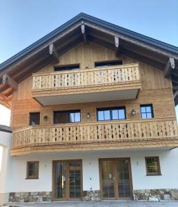 a wooden building with a balcony on it at Obereggut in Hof bei Salzburg