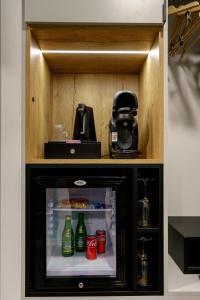 a small refrigerator with drinks inside of it at Kamienica no 111a in Warsaw