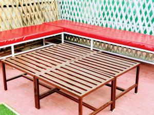 a red bench sitting on top of a sidewalk at Backpacker's Nest in Amritsar