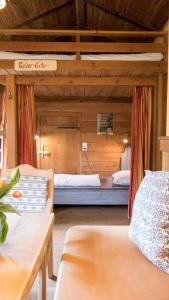 a bedroom with two beds in a wooden room at Haslaustube in Schwarzenbach an der Pielach