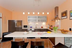 a kitchen with a large white table and chairs at FH Das blaue Haus am Peenestrom in Peenemünde