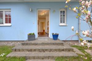 a blue house with stairs leading to the front door at FH Das blaue Haus am Peenestrom_BL in Peenemünde