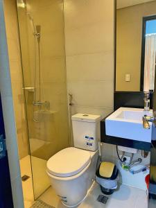 a bathroom with a toilet and a shower and a sink at Cozy studio unit in Boracay Newcoast in Boracay