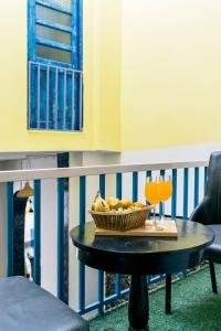 a table with a bowl of fruit and drinks on a balcony at Barefoot Boutique Hotel Udaipur in Udaipur