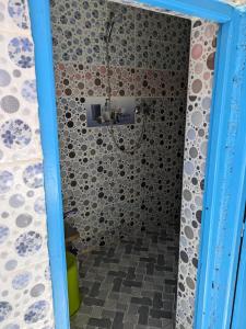 a bathroom with a shower with a glass door at Authentic Moroccan Family Homestay 